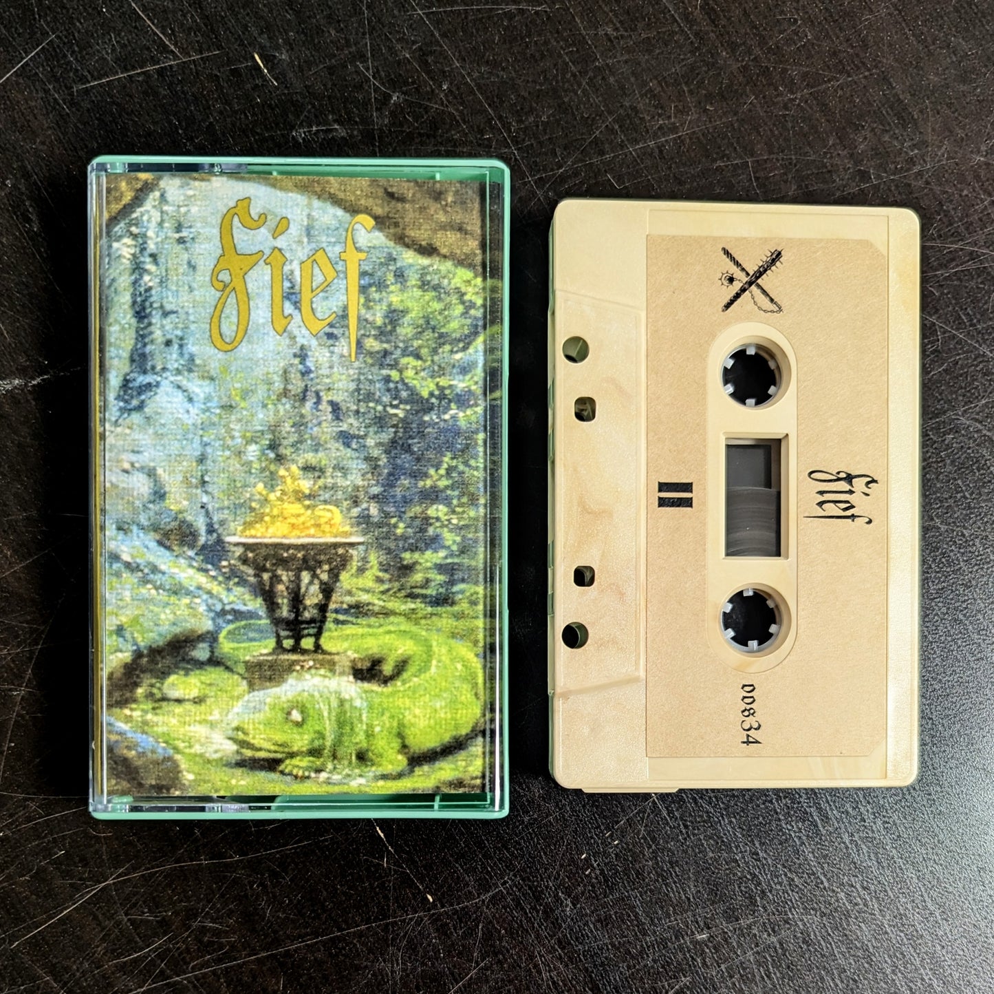 FIEF II cassette tape, sand colored cassette shell with printed sticker label, mint green Norelco case and printed j-card