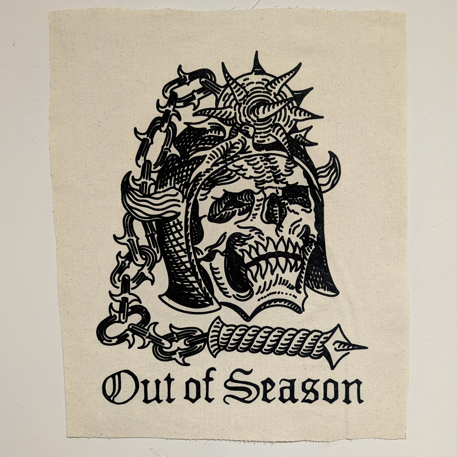 Out of Season Skull n' Flail back patch, natural canvas back patch with black print of skull with flail embedded