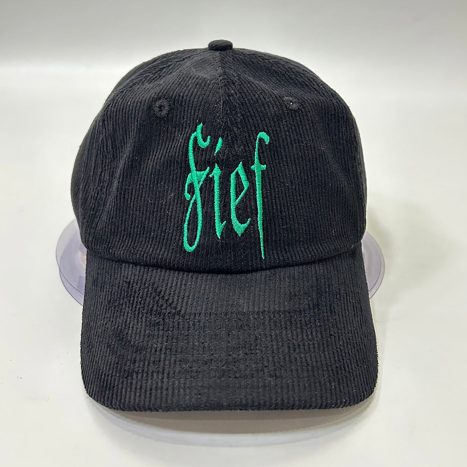 Black corduroy hat with Fief logo in green thread